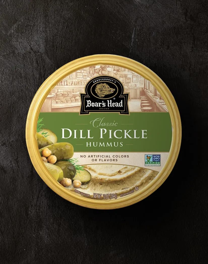 An aerial view of the Boar's Head® Dill Pickle Hummus that sits on a graphite colored background.